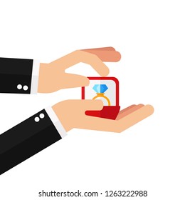 Valentines Day.Man is holding in hand an open box with a wedding ring and diamond