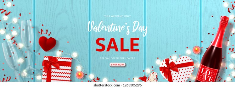 Valentine's Day holiday sale banner. Vector illustration with top view on realistic bottle of champagne, gift boxes, glasses of champagne, ring box and garlands with hearts on wooden texture.