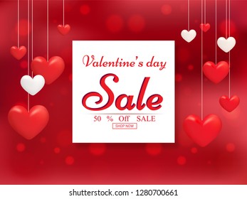 Valentine's day sale poster or banner design decorated with hanging hearts on red bokeh background.