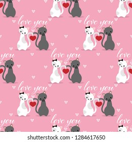 Valentine's day seamless pattern of cute cats couple with red heart and Love you text on pink background with tiny white hearts. Vector illustration.