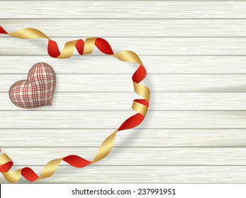 Valentines day toy heart and ribbon over wooden table background with copy space. EPS 10 vector file included