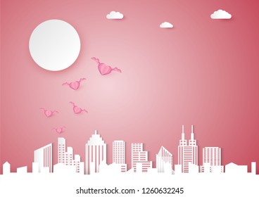 Valentines day vector background with pink heart shape and wing, love and cityscape concept, paper cut design