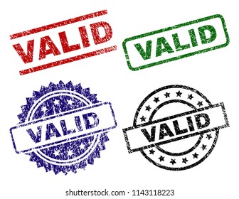 VALID seal prints with damaged texture. Black, green,red,blue vector rubber prints of VALID tag with scratched texture. Rubber seals with round, rectangle, rosette shapes.
