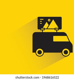 van and advertising billboard shadow on yellow background