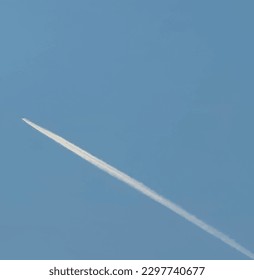 Vapor trail in blue sky and aircraft.