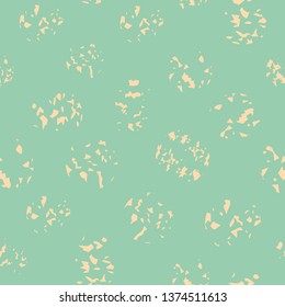 Variety of soft yellow paint spatters in random layout. Sunny seamless vector pattern on light turquoise background. Great for wellness, beauty, beach products, stationery, fabric, packaging, giftwrap