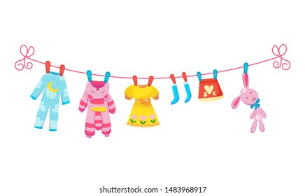 Various items of baby clothes on rope isolated vector illustration on white background. Laundry held by plastic pegs drying.