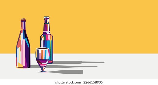 Various multi-colored bottles with wine and beer and a glass next to them. There is a copy space nearby.