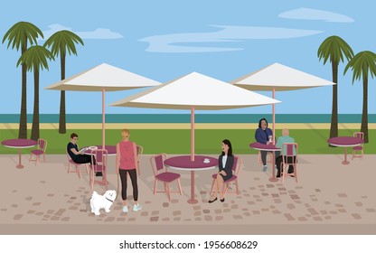 Various people dining at a beach side cafe