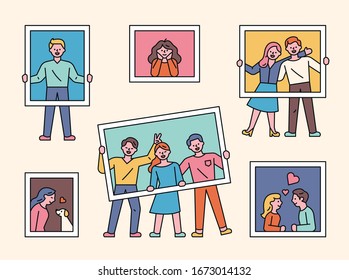 Various people are taking photos with photo frames in hand. flat design style minimal vector illustration.