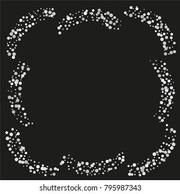 Various silver powder frame or border of random scatter silvery geometric figures isolated on black.