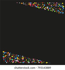 Various sparkle frame or border of random scatter rainbow geometric figures isolated on black.