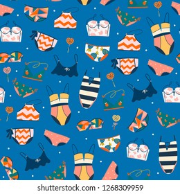 Various swimsuits. Hand drawn colored vector seamless pattern. Blue background