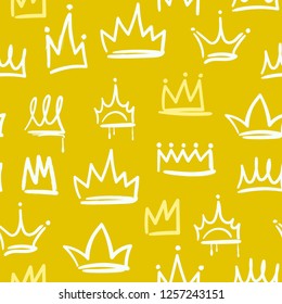 Various yellow and white doodle crowns. Golden background. Hand drawn vector seamless pattern