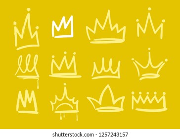 Various yellow and white doodle crowns. Golden background. Hand drawn vector set. All elements are isolated