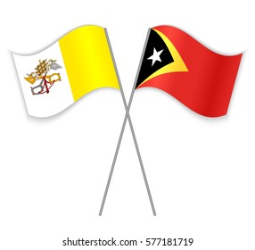 Vatican and Timorese crossed flags. Vatican City State combined with East Timor isolated on white. Language learning, international business or travel concept.