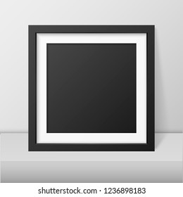 Vector 3d Realistic Modern Interior Black Blank Vertical Square Wooden Poster Picture Frame on Table, Shelf Closeup on White Wall, Mock-up. Empty Poster Frame Design Template for Mockup, Presentation