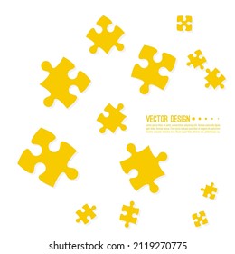 Vector abstract background with chaotically scattered jigsaw puzzle pieces in yellow. 