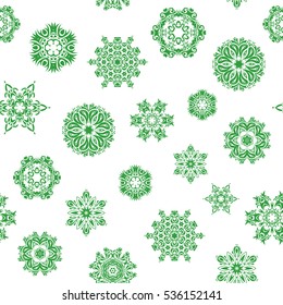 Vector abstract design in green colors. Seamless pattern of green snowflakes and dots on white background.