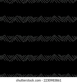 Vector.  Abstract monochrome ethnic seamless pattern. Artistic background hand drawn simple shapes of angle brackets, checkmarks. Mosaic abstract background. Repeating geometric texture. Dividers.