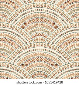 Vector abstract seamless geometrical background from dark colorful fan shaped ornate elements with ethnic patterns. Peacock tail silhouette with feathers on a beige background.Batik, wallpaper