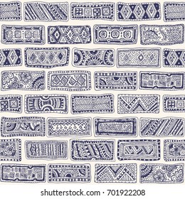 Vector abstract seamless monochrome doodle pattern. Hand drawn dark blue bricks with geometrical ornament, wavy stripes on a beige background. Textile patchwork American Indian, Aztec, Eskimo print