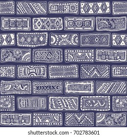 Vector abstract seamless monochrome doodle pattern. Hand drawn beige bricks with geometrical ornament, wavy stripes on a dark blue background.Textile patchwork American Indian, Aztec, Eskimo print