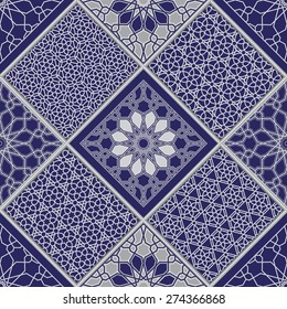 Vector abstract seamless patchy pattern from light grey and white geometric Oriental ornaments, stylized flowers, stars and radial rosette on dark indigo blue background