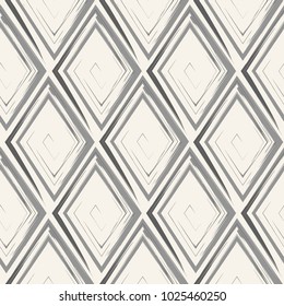 Vector abstract seamless pattern with drawn by brush rhombuses.Modern stylish texture.White and gray