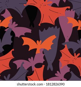 Vector abstract seamless pattern of Halloween silhouettes of bats in dark moody colors. The design is perfect for decorations, textiles, costumes, backgrounds, wrapping paper