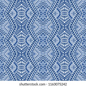 Vector abstract seamless pattern from indigo blue and light beige hand drawn geometrical shapes rhombus, triangles, Maori ornaments, wavy stripes. Textile print. Wrapping paper, wallpaper. Batik paint