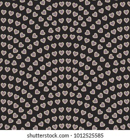 Vector abstract seamless wavy pattern with geometrical fish scale layout. Faceted rainbow colored hearts on a dark black background. Fan shaped Valentine Day ornament. Wrapping paper, wallpaper
