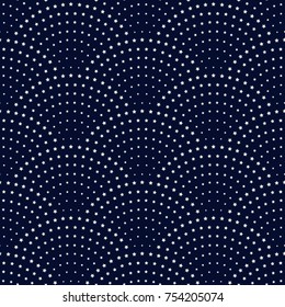 Vector abstract seamless wavy pattern with geometrical fish scale layout. Silver blue metallic stars on a dark indigo blue background. Fan shaped Christmas garlands .New Year snowflake decoration