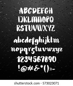 Vector alphabet. Hand drawn letters. Letters of the alphabet written with brush. Calligraphy white letters on black chalkboard background. Vector illustration stock vector.