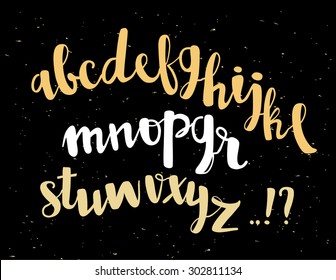 Vector alphabet lettering written with brush pen. Hand drawn letters. Black background with gold foil
