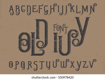 Vector alphabet set. Capital grunge letters with decorative flourishes in the Art Nouveau style. Black font on brown background.