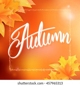 vector autumn background with autumn leaves, frame and hand written lettering word - autumn on blur background.