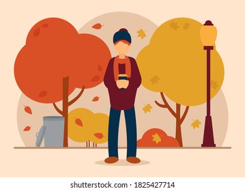 Vector autumn concept. A man in a beautiful autumn park stands with a warm cup of coffee in his hands and warms himself. Autumn weather. Lamp, trash can and trees from which leaves fall.