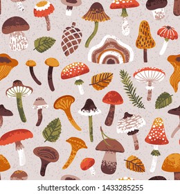 Vector autumn seamless pattern with cute mushrooms and leaves. Repeated texture with natural elements for fall season. Hand drawn print for fabric and wrapping paper. Forest background.