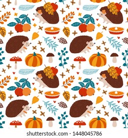 Vector autumn seamless pattern with cute hedgehogs, pumpkin pie, apples and autumn floral plants. Childish repeated texture with cartoon characters and falling leaves. Seasonal background with animals