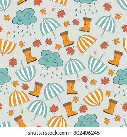 Vector autumn seamless pattern with hand drawn umbrellas, clouds, rain, falling maple leaves, rubber boots. Can be used for background, card template, fabric print, scrapbooking paper