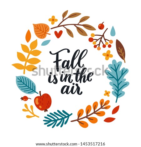 Vector autumn wreath with falling leaves, apple, rowan, fall floral elements and hand written quote "Fall is in the". Bright round frame made from hand drawn botanical elements. Isolated on white.