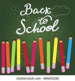 Vector background. Back to school. Colored pencils on a green background. Eps10.
