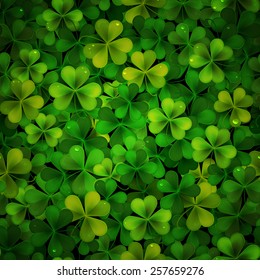 Vector background with green realistic Saint Patricks day shamrock leaves