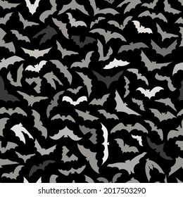 Vector background for Halloween design. 
Seamless pattern with gray flying bats isolated on black background. 
