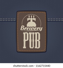 Vector banner for brewery or pub with a leather label depicting a beer barrel with faucet on a background of denim fabric