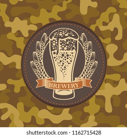 Vector banner for craft beer with a leather label depicting a full beer glass with ears of wheat on a background of camouflage fabric