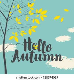 Vector banner with the inscription Hello autumn. Autumn landscape with yellow leaves on the branches of trees in a Park or forest on a background of blue sky with clouds