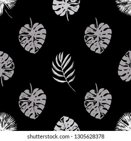 Vector beach seamless pattern wallpaper of black and white tropical leaves of palm trees on a black background. Vector seamless pattern. Tropical illustration. Jungle foliage. Cool floral wallpaper