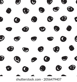 Vector black doodle polka dots on a white background seamless pattern. Hand drawn, fun and lighthearted design. Perfect for fabric, wallpaper, scrapbooking and stationery.